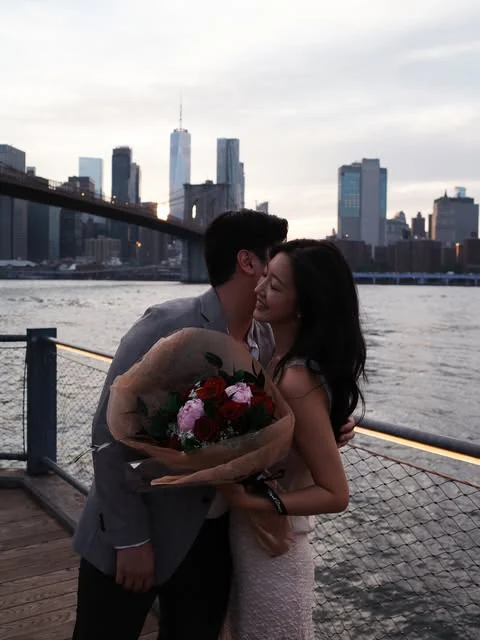 Yeaji and her fiancé with flowers by the Brooklyn waterfront
