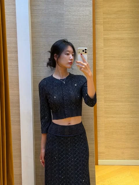 Yeaji taking a mirror photo in a black lace outfit